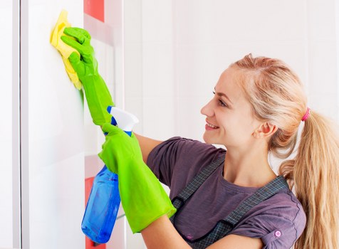 Tenant completing end of tenancy cleaning in a bright living room