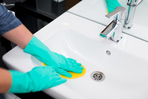 Bathroom surfaces being cleaned and sanitized