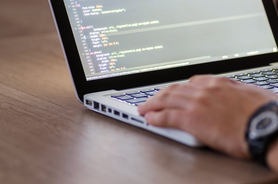 Close-up image of a computer screen displaying lines of colorful code in HTML and CSS, with a dark background. The code includes various styling elements such as padding, borders, and shadows, indicat